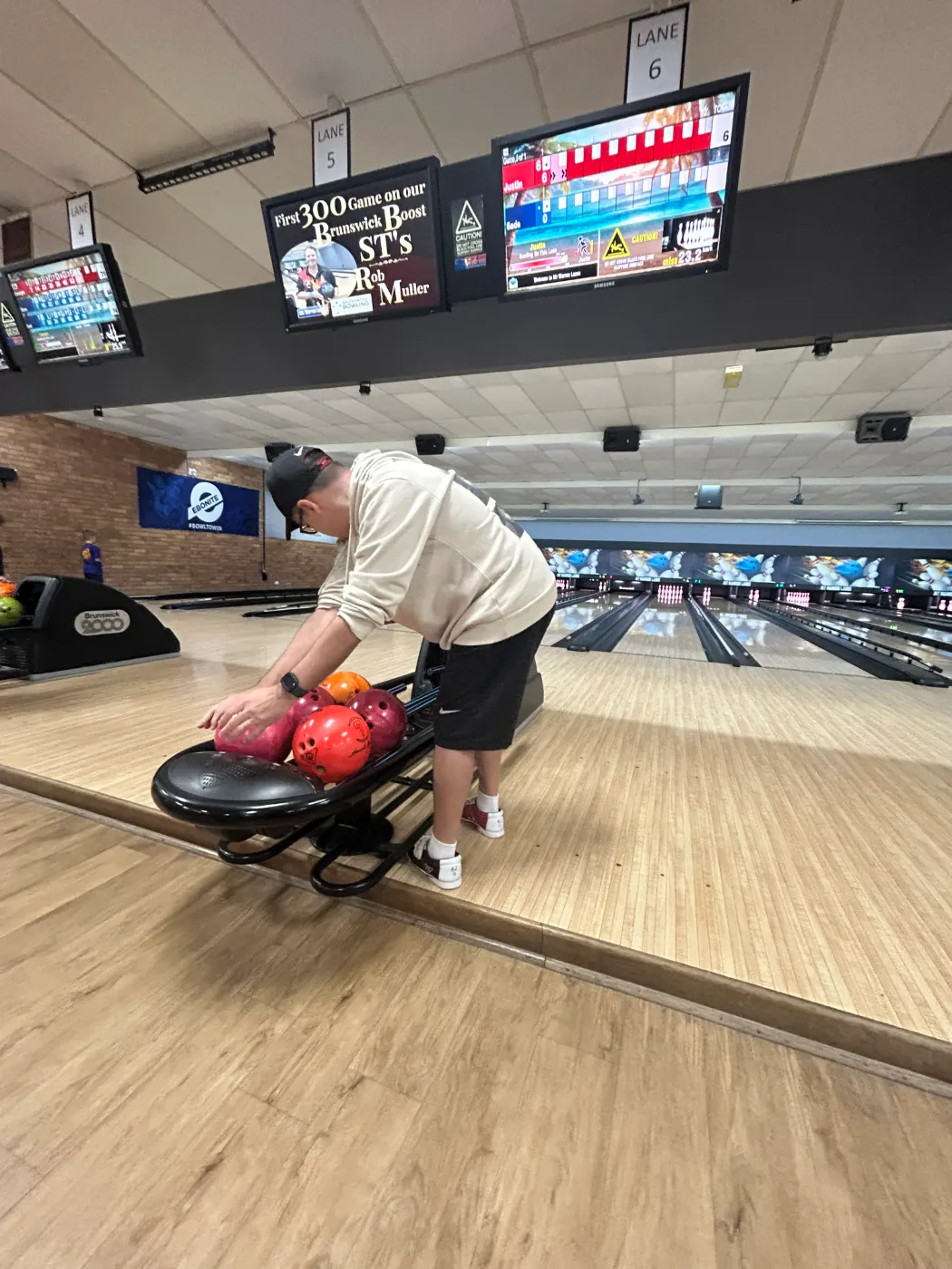 A participant choosing a bowling ball during a social outing