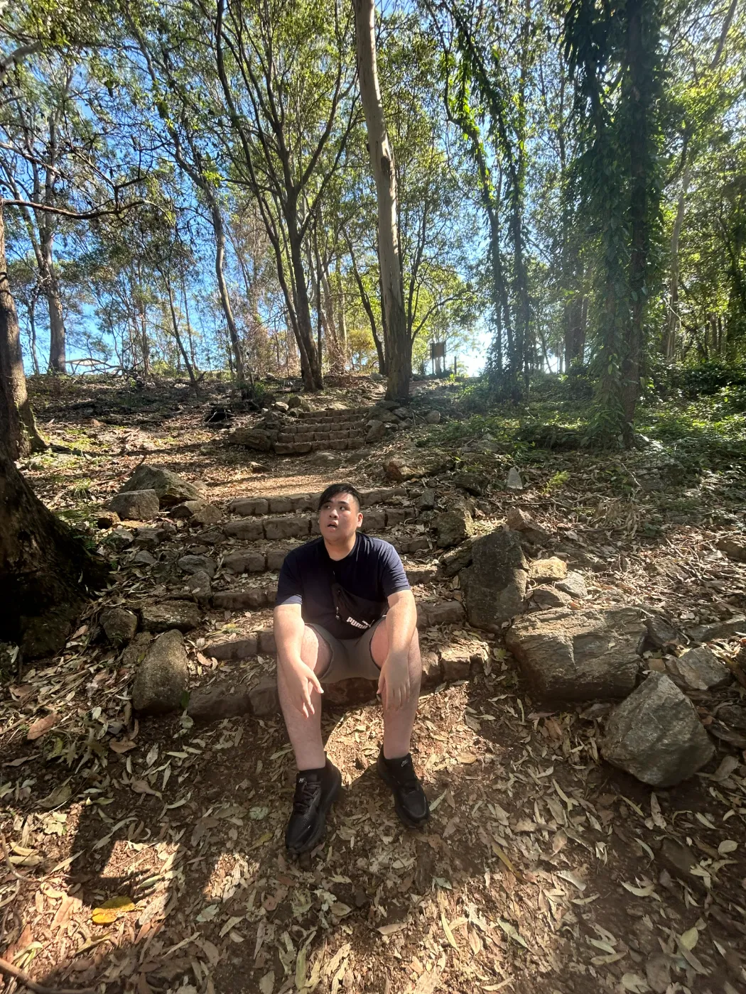 A participant taking a break during a bushwalk