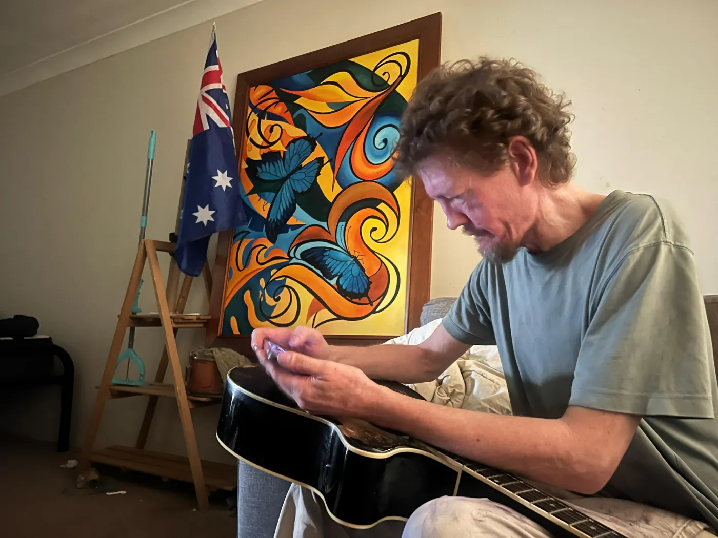A participant spending time with his guitar at home
