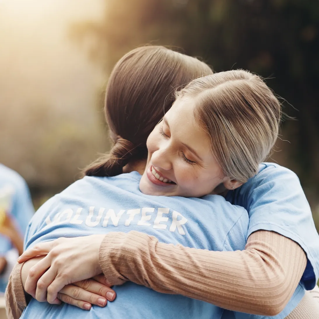 Two people sharing a warm hug