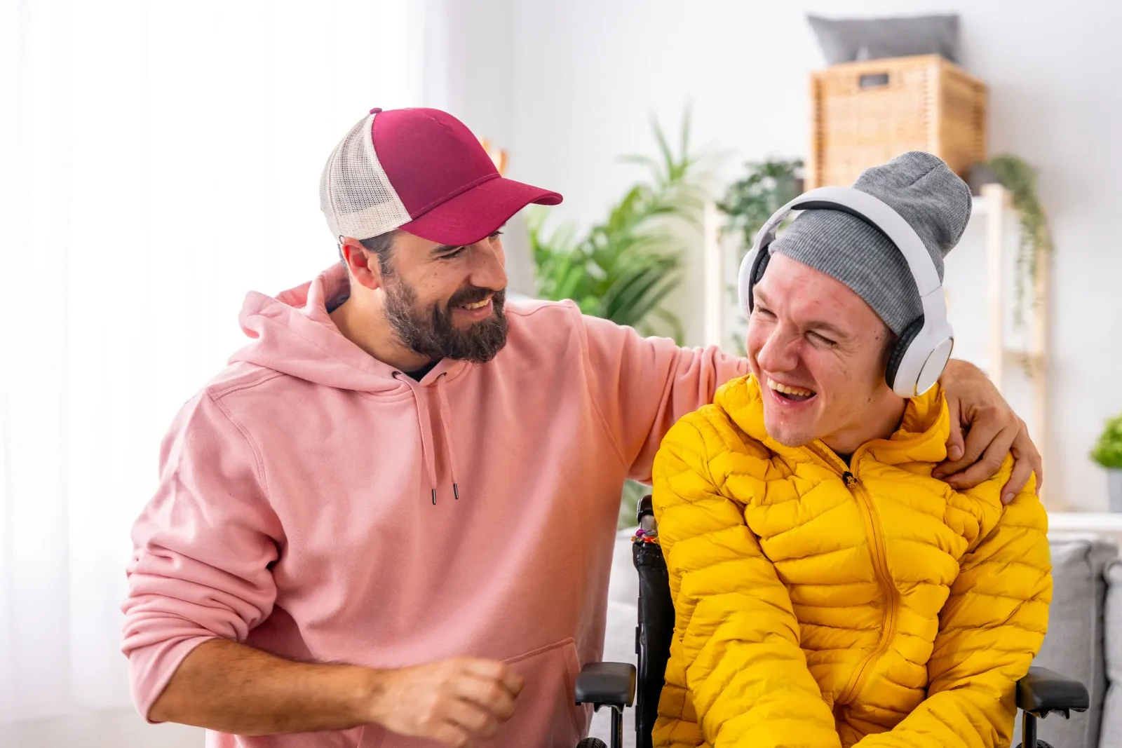 A participant and support worker laughing together